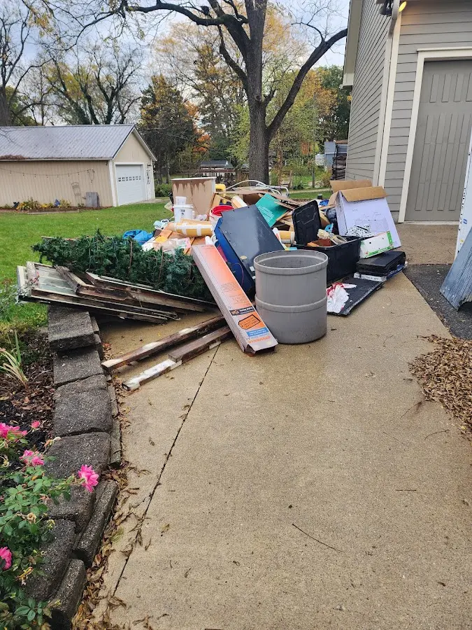 Dumpster being loaded with debris for 12 Yard Dumpster Rental in Timberwood Park